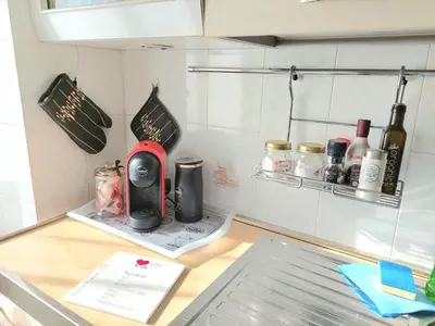 a kitchen counter with a red appliance on it at Pigneto Happy Stay in Rome