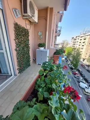 a balcony with flowers and plants on a building at Pigneto Happy Stay in Rome