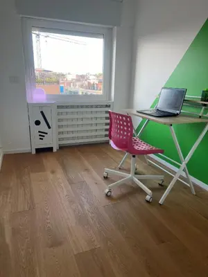 a room with a desk and a chair with a laptop at Angela attico a pochi minuti dal Gemelli e Stazione FL3 direzione San Pietro - Roma centro in Rome