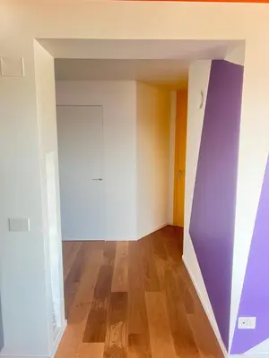 an empty room with a purple and white wall at Angela attico a pochi minuti dal Gemelli e Stazione FL3 direzione San Pietro - Roma centro in Rome