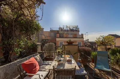 a patio with a table and chairs on a balcony at iFlat Orient in Rome in Rome