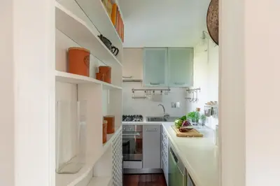 a kitchen with white cabinets and a counter top at iFlat Orient in Rome in Rome