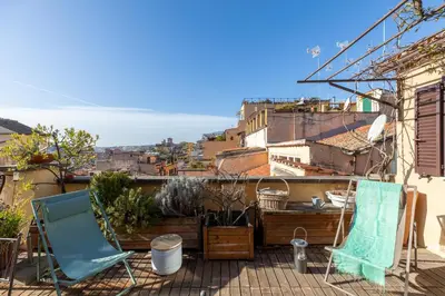 a balcony with chairs and a view of the city at iFlat Orient in Rome in Rome