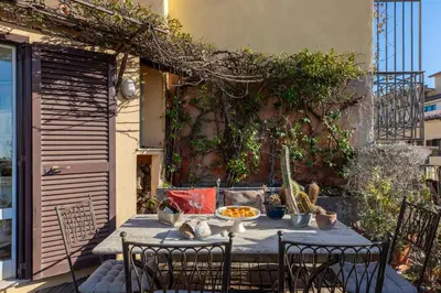 a table with chairs and a bowl of food on it at iFlat Orient in Rome in Rome
