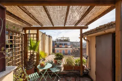 an outdoor balcony with a wooden pergola at iFlat Orient in Rome in Rome