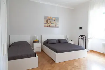 a bedroom with two beds and a picture on the wall at Cicerone 60 in Rome