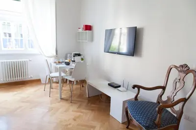 a white room with a table and a chair at Cicerone 60 in Rome