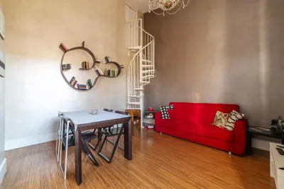 a living room with a red couch and a table at GuestHost - Roma Termini Lovely Apartment in Rome