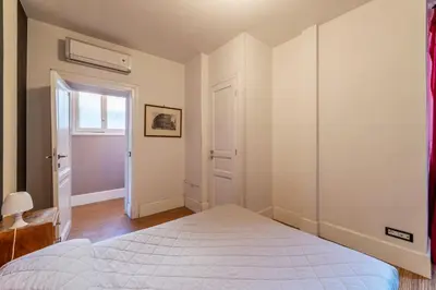 a bedroom with a bed and an open door at GuestHost - Roma Termini Lovely Apartment in Rome
