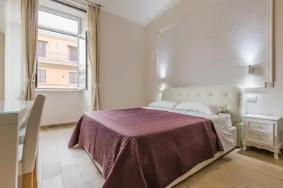 a bedroom with a bed with a purple blanket at Mirabilia House in Rome