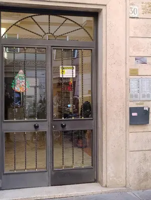 a door of a store with a sign on it at SPQR Luxury Appartments - Stazione Trastevere in Rome