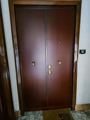 a pair of wooden doors in a room at SPQR Luxury Appartments - Stazione Trastevere in Rome