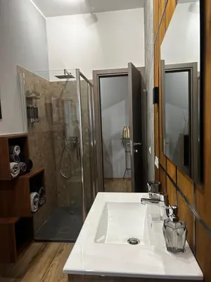 a bathroom with a white sink and a shower at SPQR Luxury Appartments - Stazione Trastevere in Rome