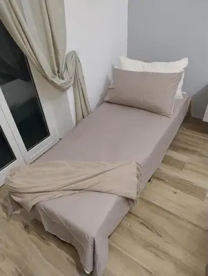 a bed with white sheets and pillows next to a window at SPQR Luxury Appartments - Stazione Trastevere in Rome