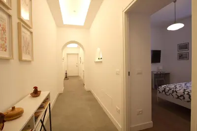 a hallway leading to a bedroom with a bed at Risorgimento Holiday Home in Rome