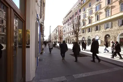 a group of people walking down a city street at Risorgimento Holiday Home in Rome