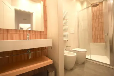 a bathroom with a sink and a toilet and a mirror at Risorgimento Holiday Home in Rome