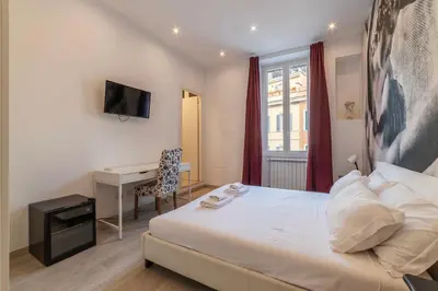 a hotel room with a bed and a desk at Major 93 Guesthouse in Rome