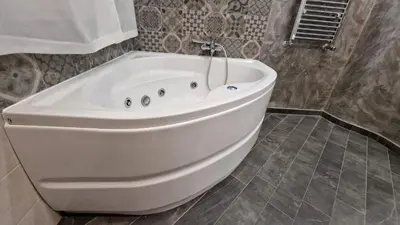 a large white bath tub in a bathroom at Major 93 Guesthouse in Rome