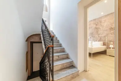 a staircase in a home with a stone wall at Major 93 Guesthouse in Rome
