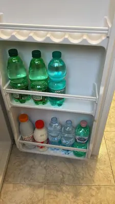 a refrigerator filled with lots of water bottles at Blue Vatican House in Rome