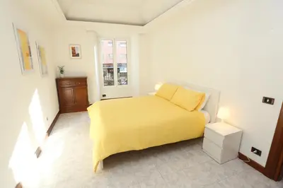 a bedroom with a yellow bed and a window at Blue Vatican House in Rome
