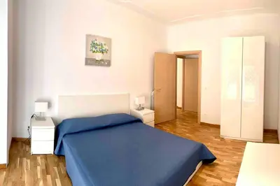 a bedroom with a blue bed in a room at Vacanze Romane in Rome