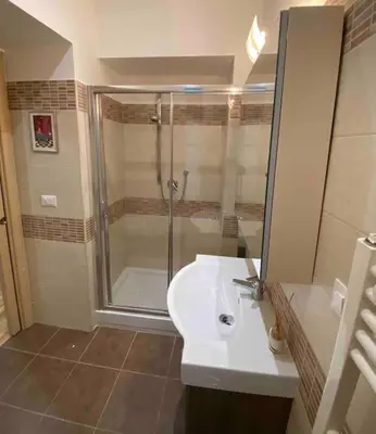 a bathroom with a shower and a white sink at Vacanze Romane in Rome