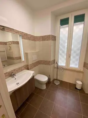 a bathroom with a tub and a toilet and a sink at Vacanze Romane in Rome