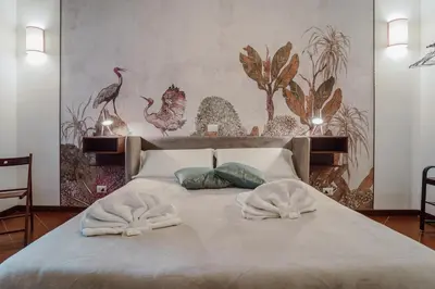 a bedroom with a bed with two towels on it at La Maisonette di Trastevere in Rome