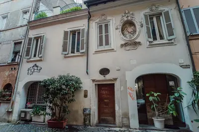 a white building with a door and a window at La Maisonette di Trastevere in Rome