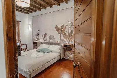 a bedroom with a bed and a wooden door at La Maisonette di Trastevere in Rome