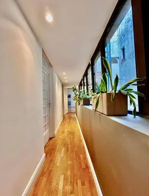 a hallway with plants on a window ledge at Campo De Fiori Home in Rome