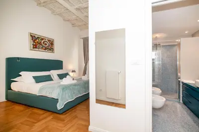 a bedroom with a bed and a bathroom at Campo De Fiori Home in Rome