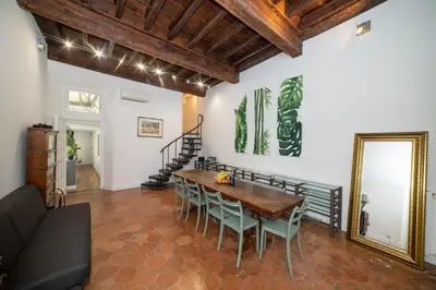 a dining room with a wooden table and chairs at Campo De Fiori Home in Rome
