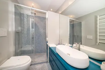 a bathroom with two sinks and a shower at Campo De Fiori Home in Rome