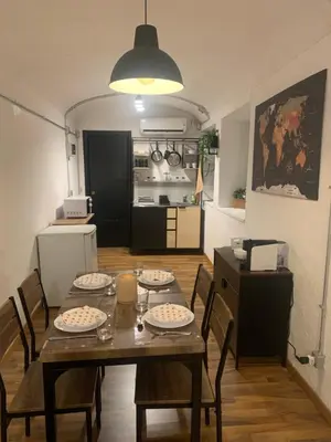 a table and chairs in a room with a kitchen at DOMUS LAURA Rione MONTI in Rome