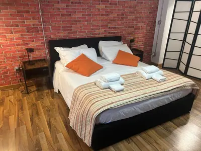 a bed with towels on it in a brick room at DOMUS LAURA Rione MONTI in Rome