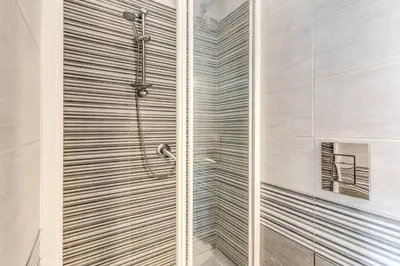 a shower with a glass door in a bathroom at Re di Roma Lovely Apartments in Rome
