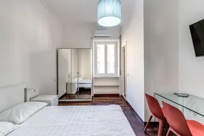 a bedroom with a bed and a table and chairs at Re di Roma Lovely Apartments in Rome