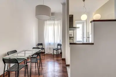a dining room with a glass table and chairs at Re di Roma Lovely Apartments in Rome
