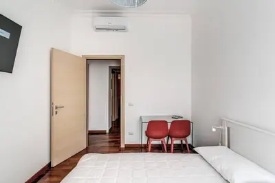 a bedroom with two red chairs and a bed at Re di Roma Lovely Apartments in Rome