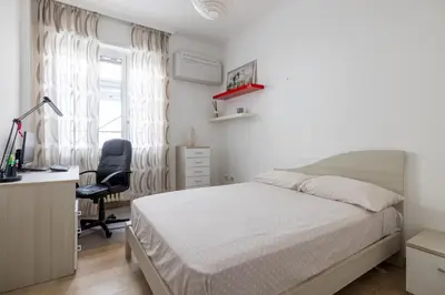 a bedroom with a bed and a desk and a chair at [CASA LUCIA 5 stelle] Lungotevere della Vittoria in Rome