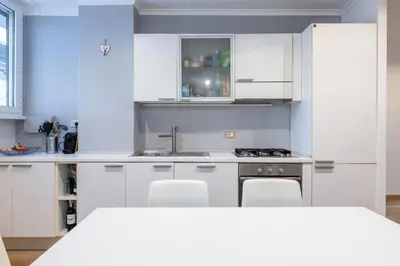 a kitchen with white cabinets and a sink at [CASA LUCIA 5 stelle] Lungotevere della Vittoria in Rome