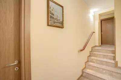 a painting on a wall next to a stairway at Top Floor Navona in Rome