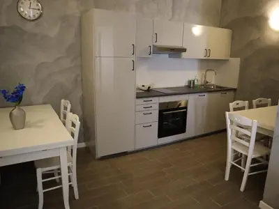 a kitchen with a white refrigerator and a table and chairs at Top Floor Navona in Rome