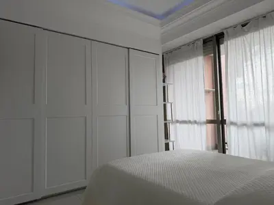 a white bedroom with a bed and a window at GREEN HOUSE - PARCO TIRRENO by Ohana in Rome