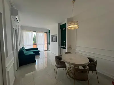 a living room with a table and chairs and a couch at GREEN HOUSE - PARCO TIRRENO by Ohana in Rome