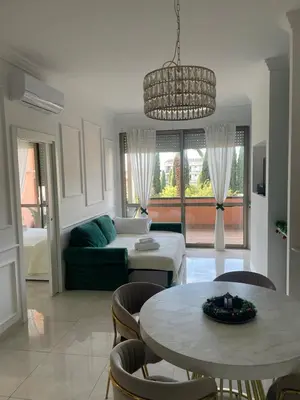 a living room with a couch and a table at GREEN HOUSE - PARCO TIRRENO by Ohana in Rome