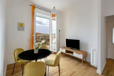 a living room with a table and chairs and a television at Casa Vespi by Hili in Rome